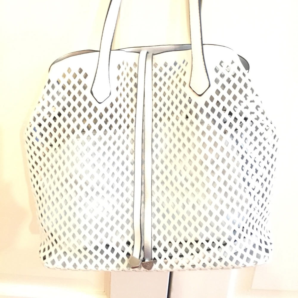 White tote bag with cross additional body strap.